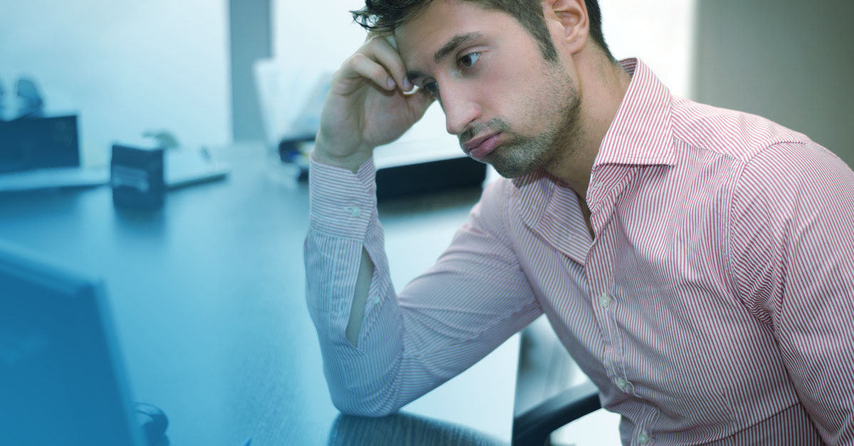 Tired or frustrated office worker looking at computer screen